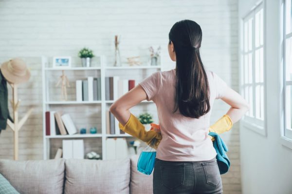 a woman getting ready to declutter and clean her living space