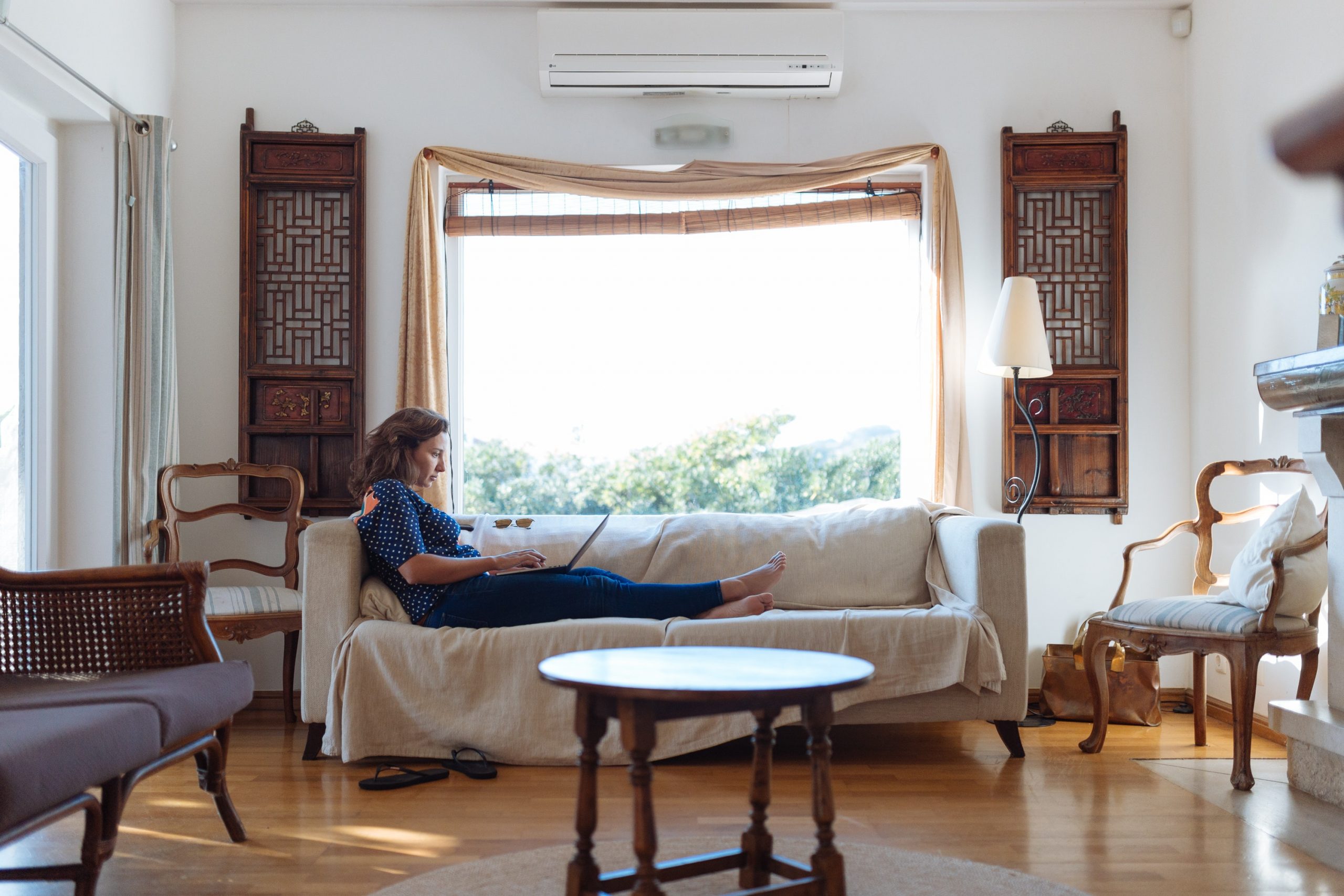 Woman Sitting on Sofa in Living Room