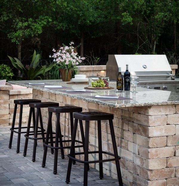 a modern outdoor kitchen with a granite counter top