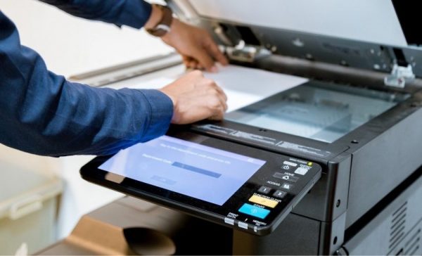 a man operating a photocopy machine