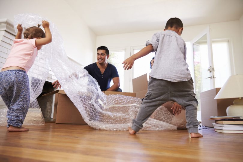 family unpacking surrounded by bubblewrap